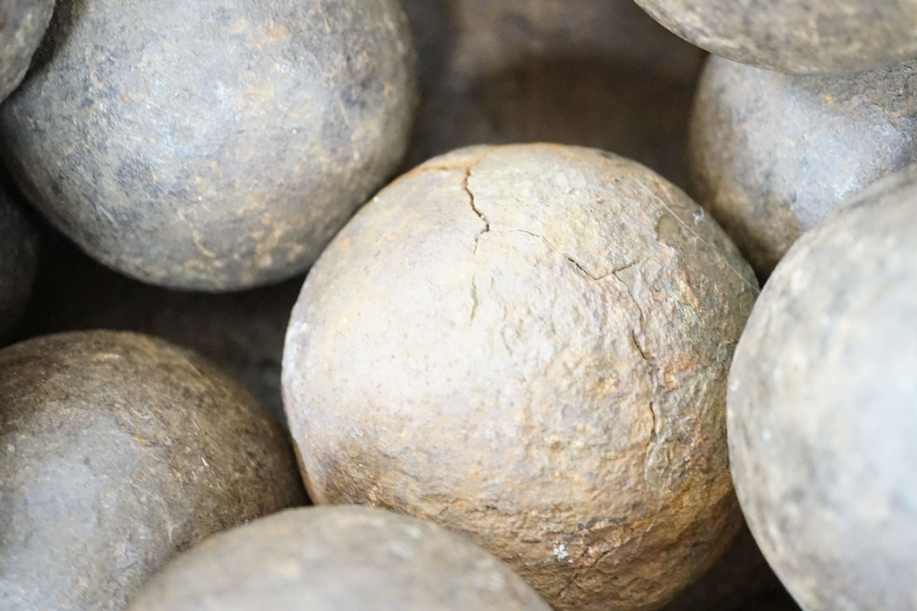 18 iron cannon balls in an iron bowl